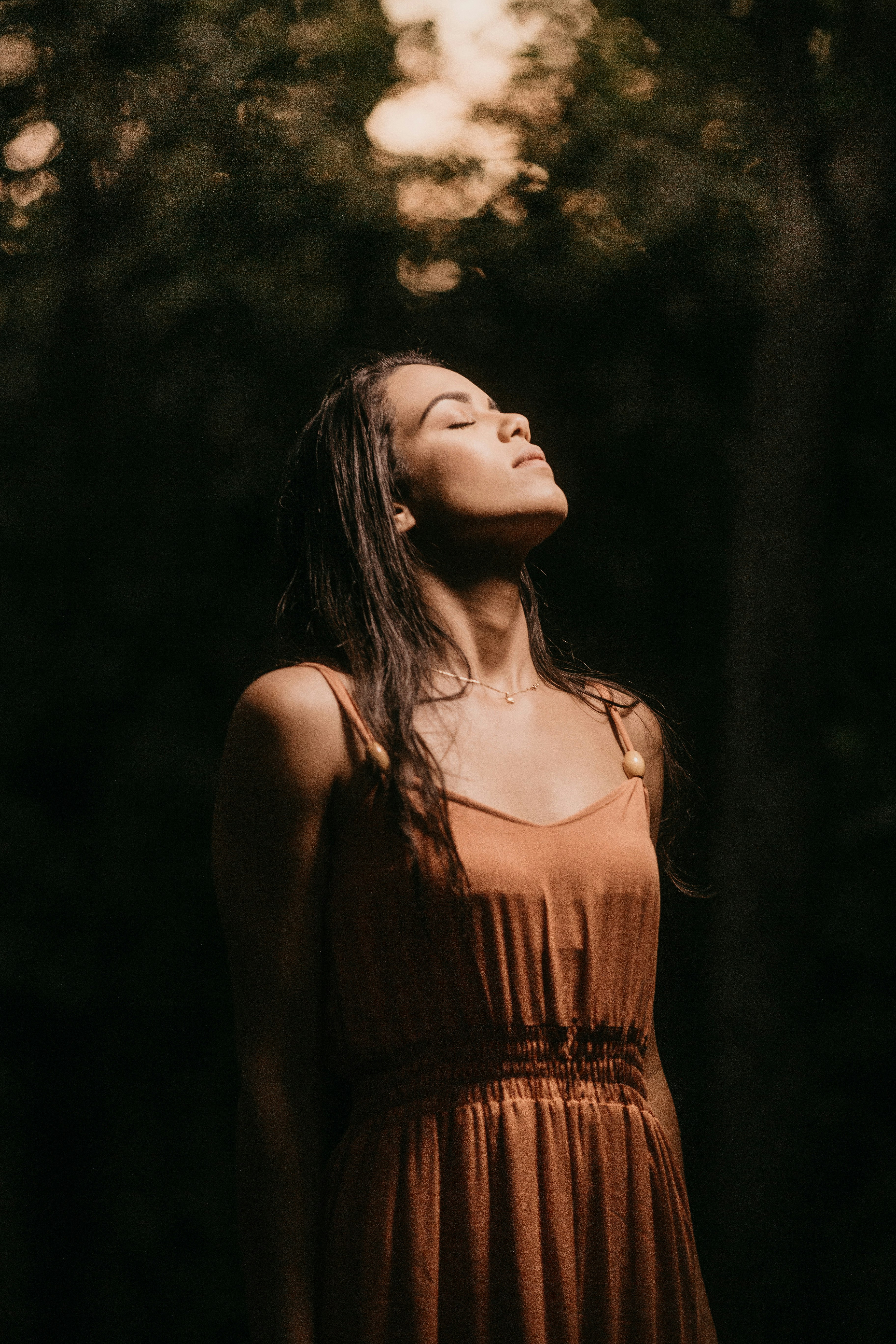 woman in brown spaghetti strap top